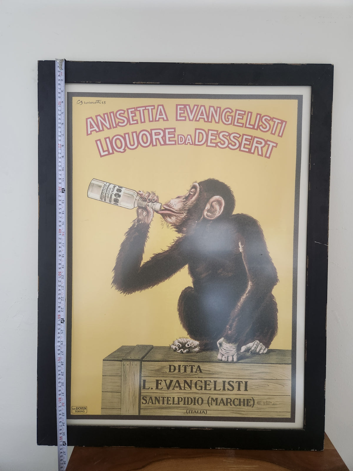Anisetta Evangelisti drinking monkey poster after Carlo Biscaretti, framed reproduction, shown with tape measure for height