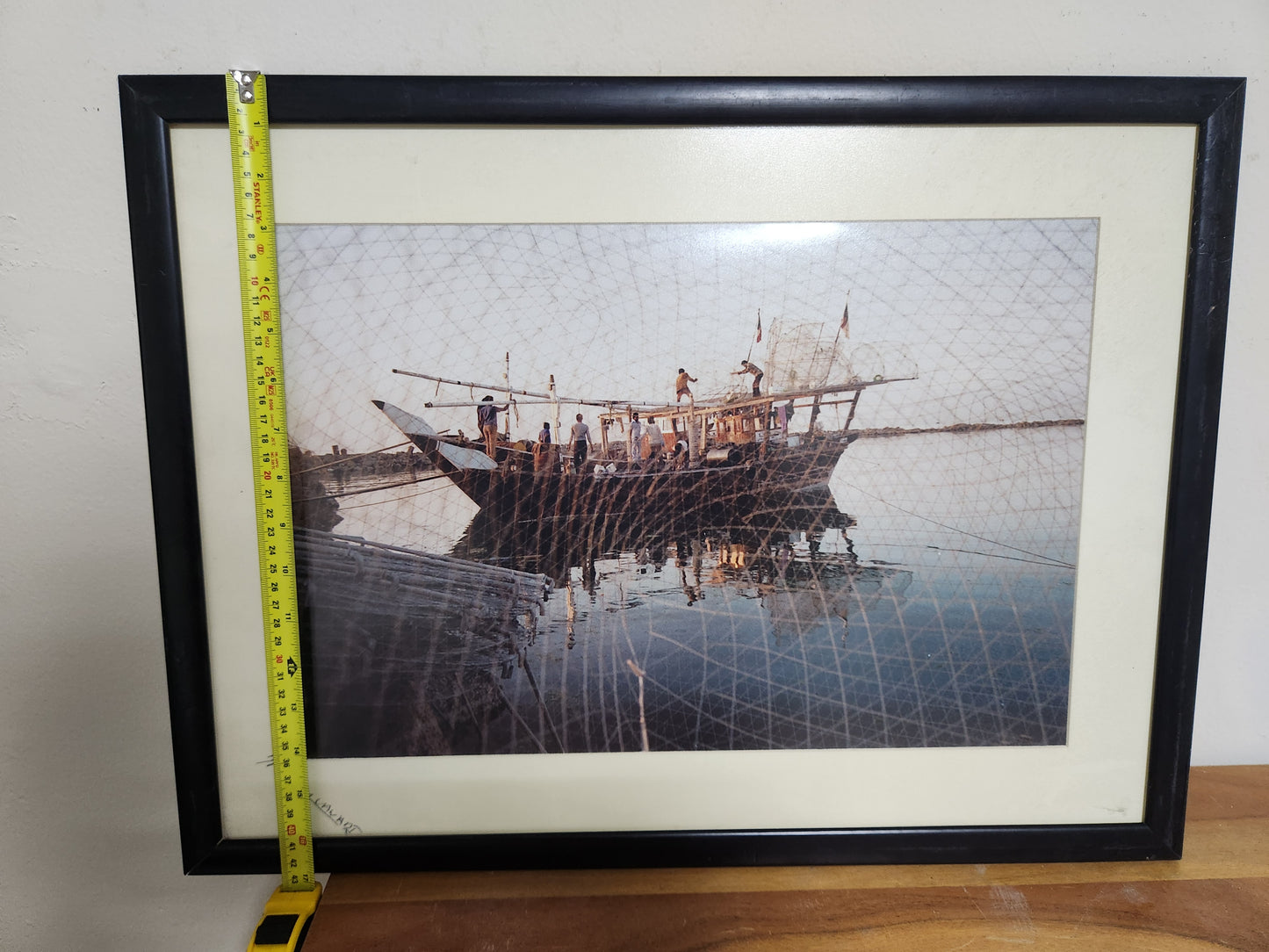 Framed photograph of a Kuwaiti dhow and crew at first light, shown with tape measure for height, approx. 40 cm