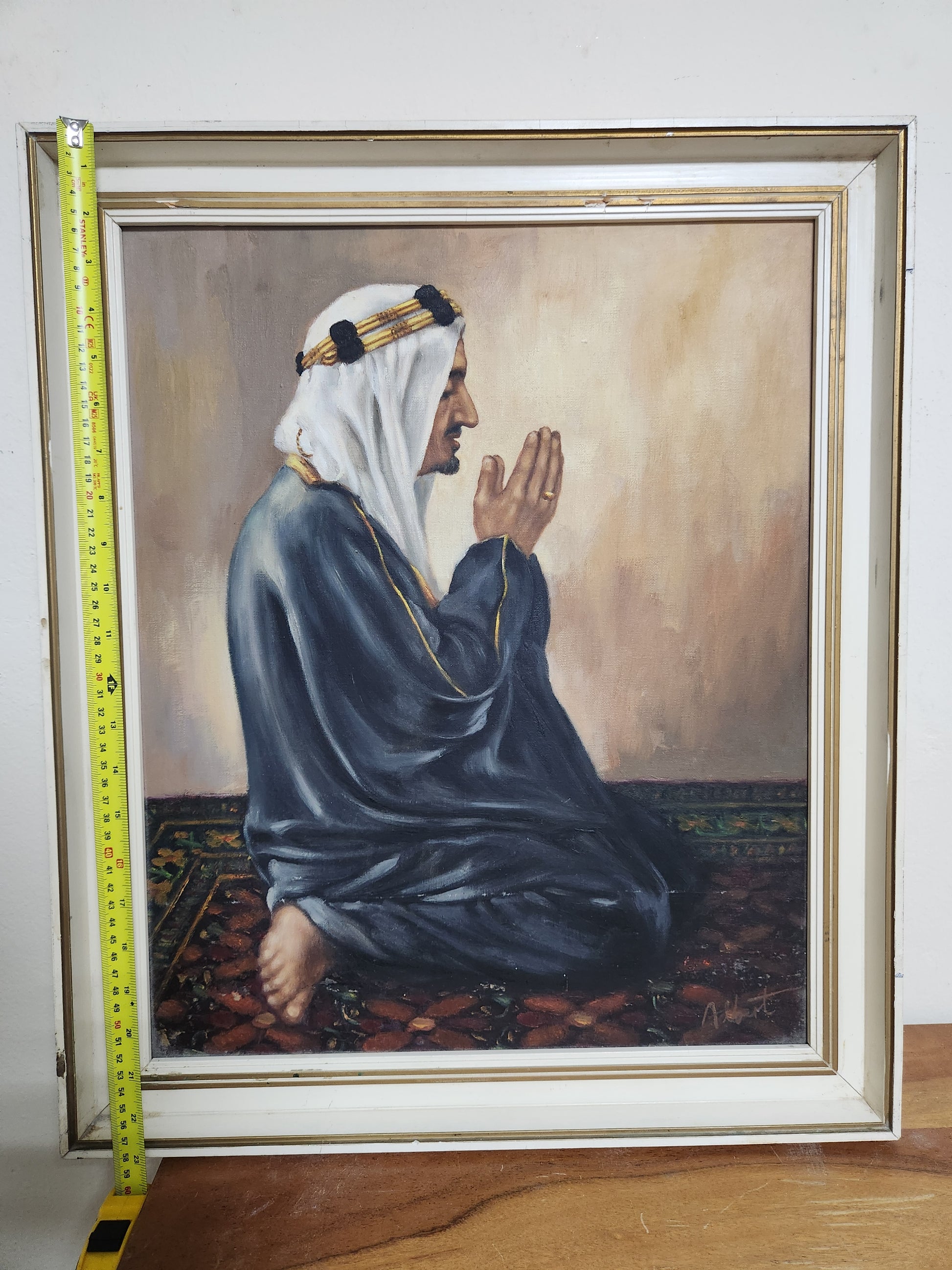 Orientalist oil portrait of a man at prayer, framed, shown with tape measure for height, approx. 60 cm